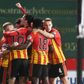 Partick Thistle's players celebrate a fine win.