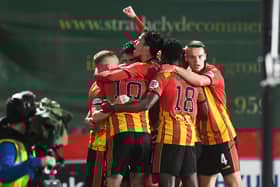 Partick Thistle's players celebrate a fine win.