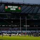 Some players stand and others take the knee in support of the Black Lives Matter movement ahead of the Six Nations rugby union match between England and Scotland at Twickenham Stadium in south west London on February 6, 2021. (Photo by Adrian DENNIS / AFP) (Photo by ADRIAN DENNIS/AFP via Getty Images)