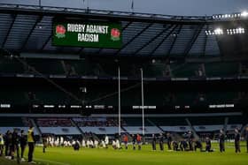 Some players stand and others take the knee in support of the Black Lives Matter movement ahead of the Six Nations rugby union match between England and Scotland at Twickenham Stadium in south west London on February 6, 2021. (Photo by Adrian DENNIS / AFP) (Photo by ADRIAN DENNIS/AFP via Getty Images)