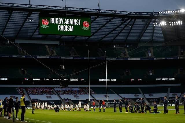 Some players stand and others take the knee in support of the Black Lives Matter movement ahead of the Six Nations rugby union match between England and Scotland at Twickenham Stadium in south west London on February 6, 2021. (Photo by Adrian DENNIS / AFP) (Photo by ADRIAN DENNIS/AFP via Getty Images)