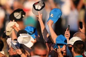 Spectators twirl their hats and caps at Patrick Cantlay during the Saturday afternoon fourball matches in the Ryder Cup in Rome. Picture: Ross Kinnaird/Getty Images.