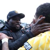 George Elokobi, manager of Maidstone United, embraces with Liam Sole after the FA Cup win over Stevenage.