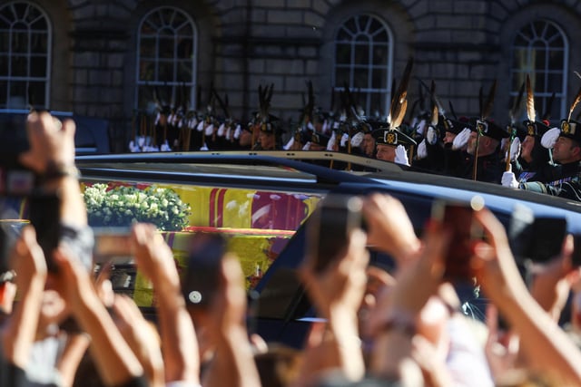 Royal Archers salute the coffin of Queen Elizabeth II as it departs St Giles' Cathedral, Edinburgh, after a prayer service.