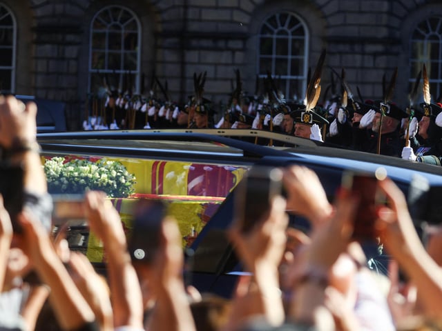Royal Archers salute the coffin of Queen Elizabeth II as it departs St Giles' Cathedral, Edinburgh, after a prayer service.