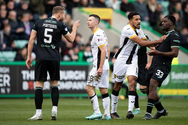 Hibs' Ryan Porteous exchanges words with Jason Holt following the tackle that earned the Livingston man a red card. (Photo by Paul Devlin / SNS Group)