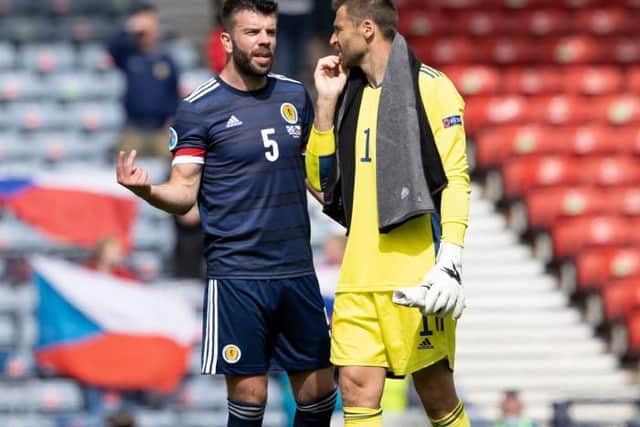 Grant Hanley and David Marshall start the post-mortem into Scotland's 2-0 defeat against Czech Republic at Hampden after the full-time whistle. (Photo by Alan Harvey / SNS Group)