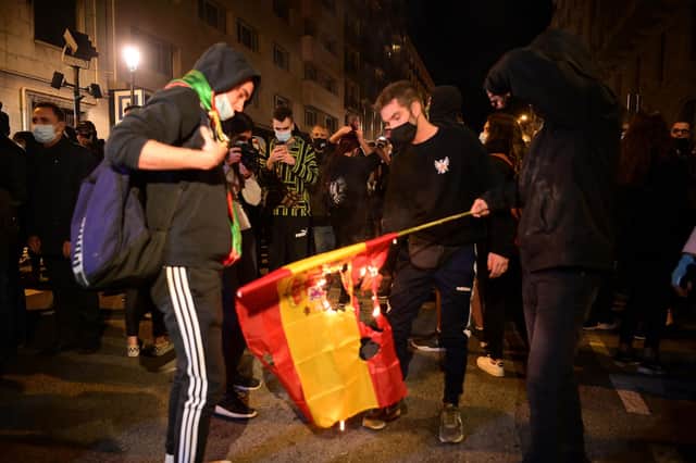 Supporters of Catalonian independence burn a Spanish flag during a protest in Barcelona (Picture: Lluis Gene//AFP via Getty Images)