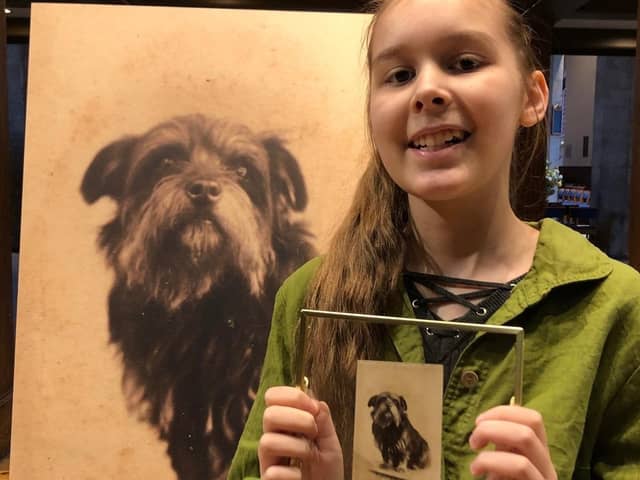 Friends of Dalry Cemetery volunteer Lani Knott with the photo of Greyfriars Bobby. Picture: Friends of Dalry Cemetery