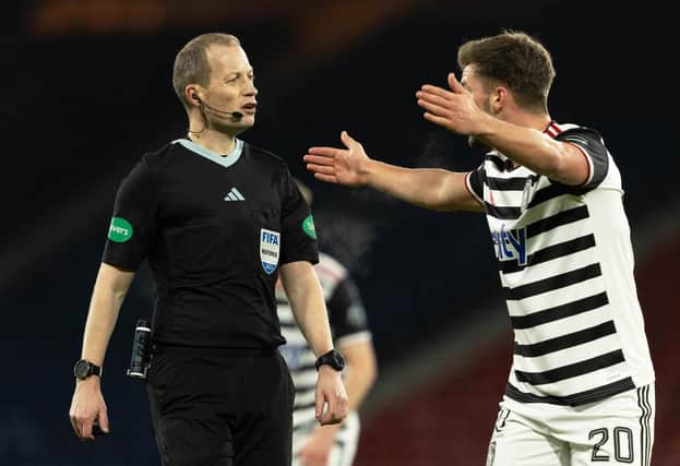 Queen's Park's Jack Turner is unhappy with Willie Collum during the match at Hampden.