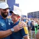 Rory McIlroy and Jon Rahm of Team Europe celebrate following Sunday's win in the 44th Ryder Cup at Marco Simone Golf & Country Club in Rome. Patrick Smith/Getty Images.