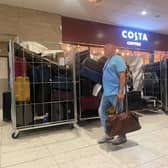 Unattended bags, including some in open cages, in an Edinburgh Airport terminal corridor on Thursday. (Photo by Louise Murray)