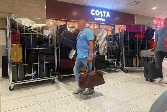 Unattended bags, including some in open cages, in an Edinburgh Airport terminal corridor on Thursday. (Photo by Louise Murray)