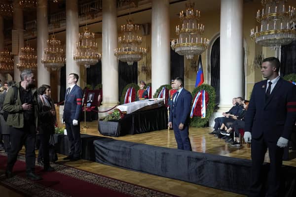 People walk past the coffin of former Soviet President Mikhail Gorbachev inside the Pillar Hall of the House of the Unions during a farewell ceremony in Moscow