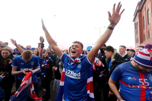 Rangers fans celebrate outside of the Ibrox Stadium after Rangers win the Scottish Premiership title. Picture date: Sunday March 7, 2021.