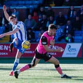 Kilmarnocks' Ash Taylor scores to make it 1-0 during the cinch Championship match between Kilmarnock and Queen of the South at Rugby Park.