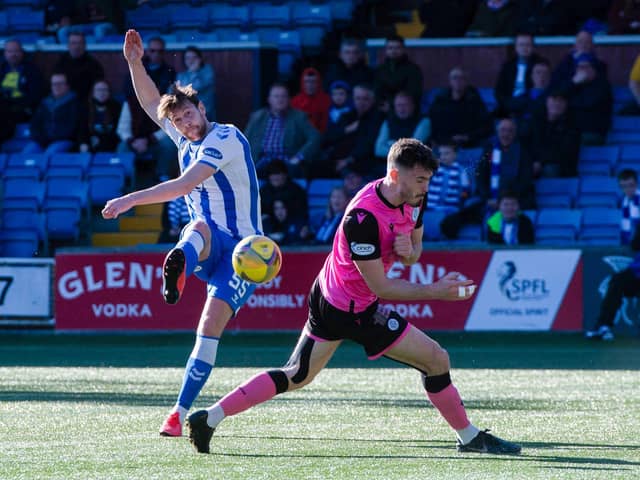Kilmarnocks' Ash Taylor scores to make it 1-0 during the cinch Championship match between Kilmarnock and Queen of the South at Rugby Park.
