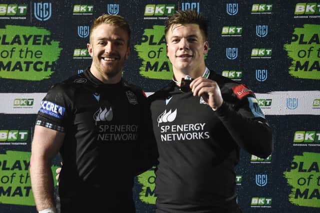 Warriors' Huw Jones, right, after receiving his player of the match award from captain Kyle Steyn. (Photo by Ross MacDonald / SNS Group)