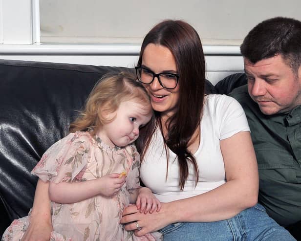 Mum Lisa Crawford and dad,Jordan Tripney with two-year-old Arya who has been diagnosed with a very rare, inoperable and incurable brain tumour. Pic Micheal Gillen