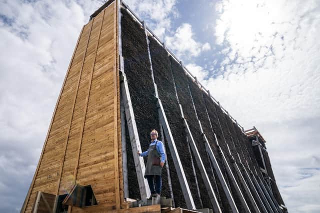 Master Salter and founder of Blackthorn Salt Gregorie Marshall alongside the new salt graduation tower on the coast at Ayr.