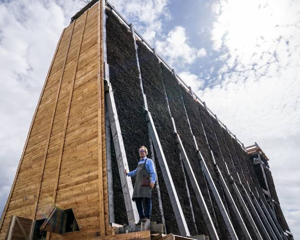 Master Salter and founder of Blackthorn Salt Gregorie Marshall alongside the new salt graduation tower on the coast at Ayr.