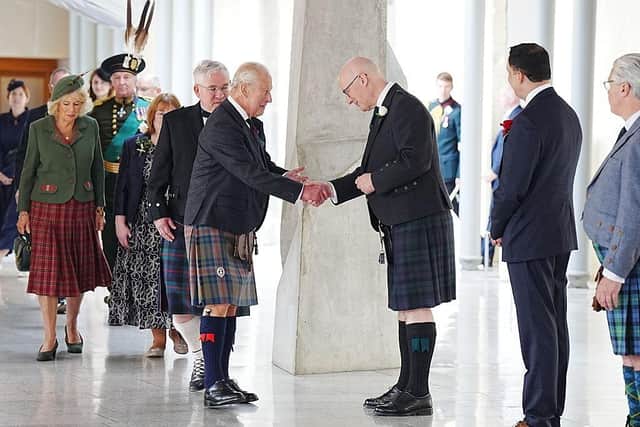 King Charles III is greeted by First Minister John Swinney ahead of the opening of the seventh session of the Scottish Parliament on June 27, but has devolution made Scotland better (Picture: Jane Barlow - Pool/Getty Images)