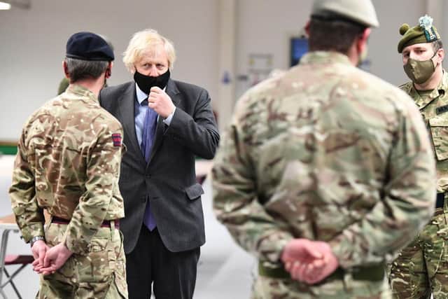 Boris Johnson meets troops as they set up a vaccination centre in the Castlemilk district on January 28, 2021 in Glasgow. (Photo by Jeff J Mitchell/Getty Images)