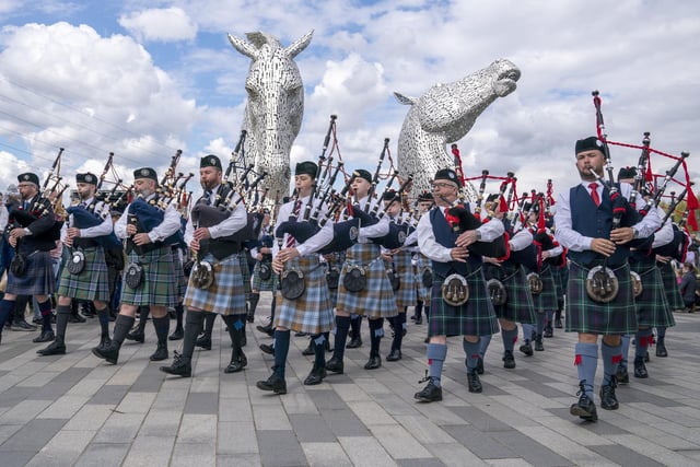 Members of the Camelon & District, Wallacestone & District and Falkirk Schools pipe bands play during a special event day to celebrate the 10th anniversary of the Kelpies