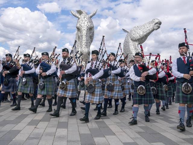 Members of the Camelon & District, Wallacestone & District and Falkirk Schools pipe bands play during a special event day to celebrate the 10th anniversary of the Kelpies