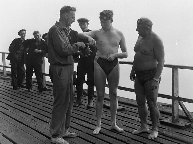 John Smith of Bathgate is coated with grease before swimming the Forth between Granton and Burntisland on 21st July 1955. He was accompanied by Channel swimmer Ned Barnie (right).