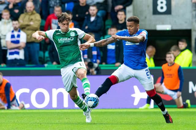 Joe Newell and James Tavernier battle for possession at Easter Road.