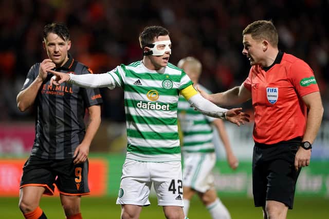 Celtic's Callum McGregor speaks with the referee John Beaton.