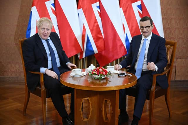 Prime Minister Boris Johnson (left) is greeted by Polish Prime Minister Mateusz Morawiecki at the Chancellery in Warsaw, Poland. Picture date: Tuesday March 1, 2022.