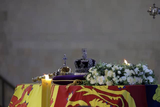 The coffin of Britain's Queen Elizabeth, draped in the Royal Standard with the Imperial State Crown and the Sovereign's orb and sceptre, is pictured on the catafalque inside Westminster Hall. Picture: Marko Djurica/Pool via AP