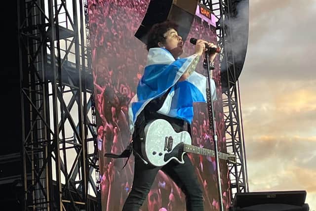 Green Day frontman Billie Joe Armstrong draped a Scotland flag over his shoulders for part of his band's headline set.