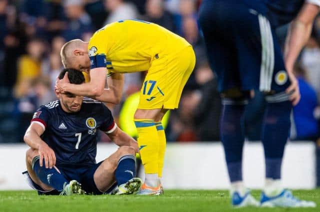 John McGinn is consoled by Ukraine's Oleksandr Zinchenko at full-time after the World Cup play-off semi-final at Hampden on June 1. (Photo by Ross MacDonald / SNS Group)