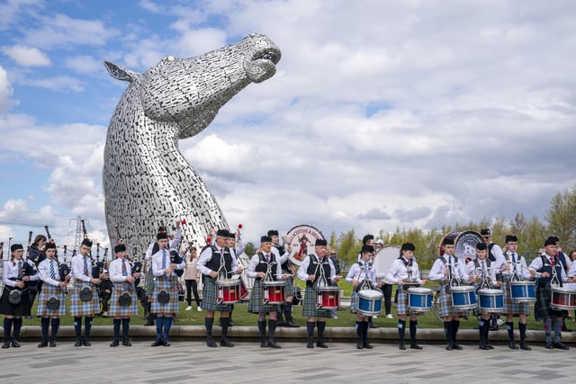 The magnificent spectacle of the Kelpies standing proud above Camelon & District, Wallacestone & District and Falkirk Schools pipe bands.