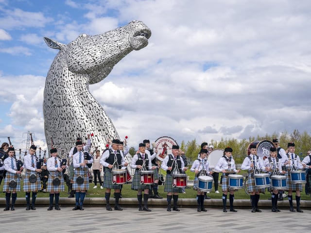 The magnificent spectacle of the Kelpies standing proud above Camelon & District, Wallacestone & District and Falkirk Schools pipe bands.