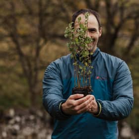 Future Forest Company founder Jim Mann holds up a sapling, one of 300,000 new native trees due to be planted at Dumyat estate, close to the historic Bannockburn battlefield and the city of Stirling. Picture: Jen Scott