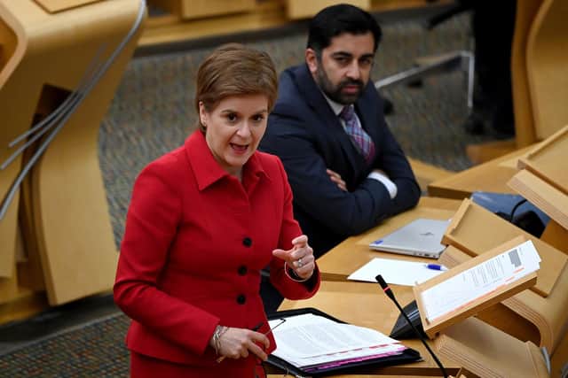 First Minister Nicola Sturgeon gives an update MSPs on any changes to the Covid-19 restrictions in the debating chamber of the Scottish Parliament in Edinburgh, as Health Secretary, Humza Yousaf looks on. Picture date: Tuesday November 23, 2021.
