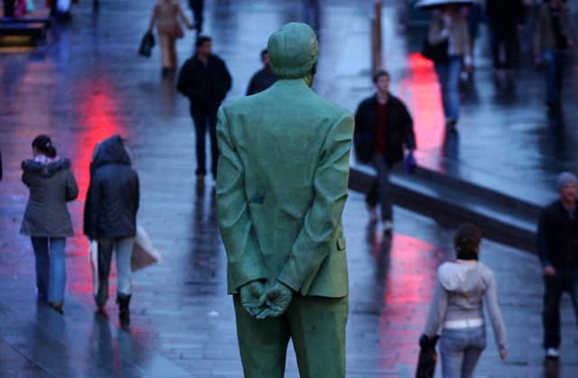 The Statue of Former First Minister Donald Dewar one of the founding fathers of the Devolution of the Scottish Parliament stands ot the top of Buchanan Street Glasgow. Shoppers pay more attention to the sales!
Photo Robert Perry The Scotsman