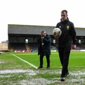 Referee Don Robertson calls the Dundee v Rangers match off during a secondary pitch inspection at Dens Park. (Photo by Ewan Bootman / SNS Group)