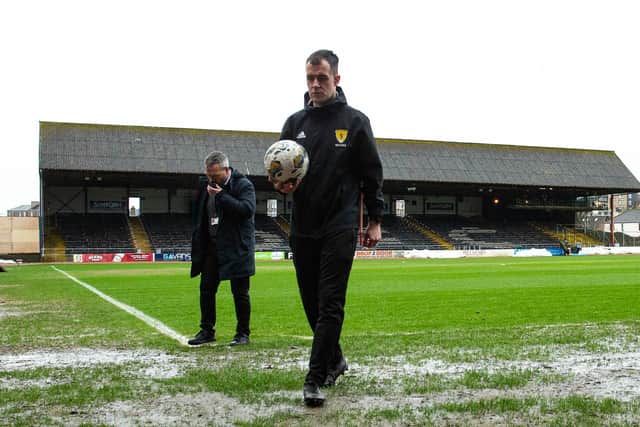 Referee Don Robertson calls the Dundee v Rangers match off during a secondary pitch inspection at Dens Park. (Photo by Ewan Bootman / SNS Group)