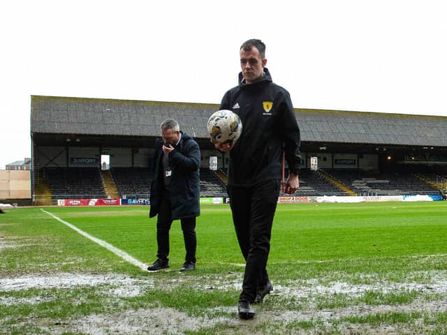 Referee Don Robertson calls the Dundee v Rangers match off during a secondary pitch inspection at Dens Park. (Photo by Ewan Bootman / SNS Group)