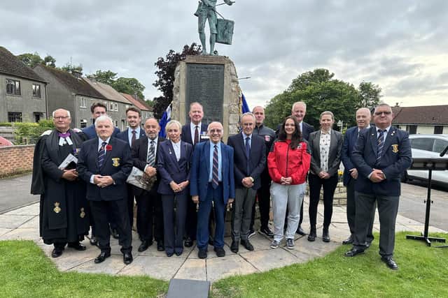 Willie Thornton's daughter Lynn joins legendary Rangers winger Willie Henderson in front of the war memorial in Winchburgh, West Lothian. Grandsons Colin and Iain are on the left of the back row.