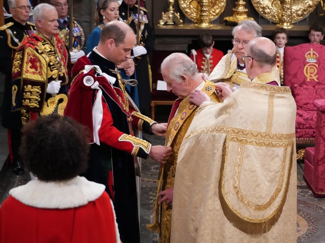The Prince of Wales places the Stole Royal on his father King Charles III during his coronation ceremony in Westminster Abbey, London.