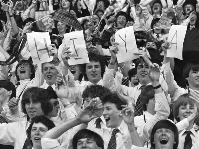 Youngster hold up a 'HIYA' sign for Pope John Paul II at Murrayfield Stadium during the Papal visit.