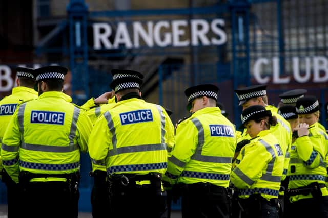 Police officers gather outside Ibrox ahead of a match