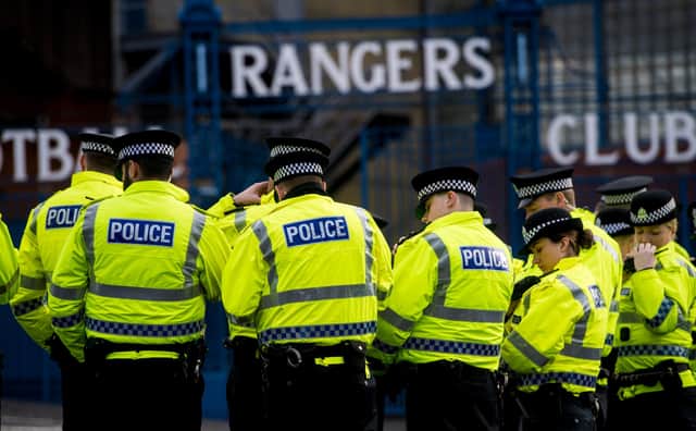 Police officers gather outside Ibrox ahead of a match