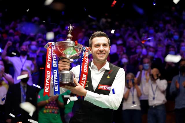 Mark Selby posses with the trophy after winning the Betfred World Snooker Championship.